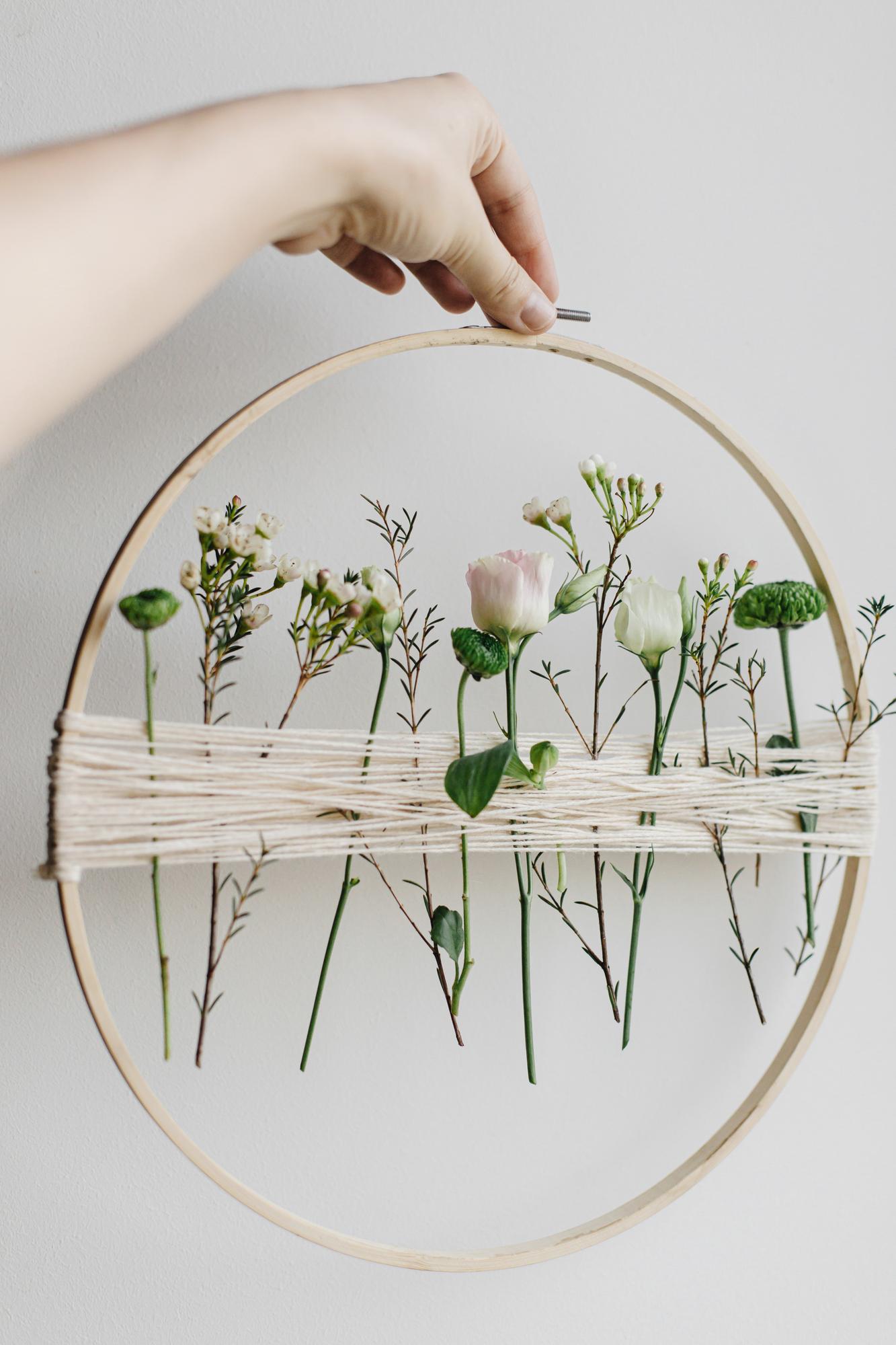 Hands holding vintage hoop with modern embroidery
